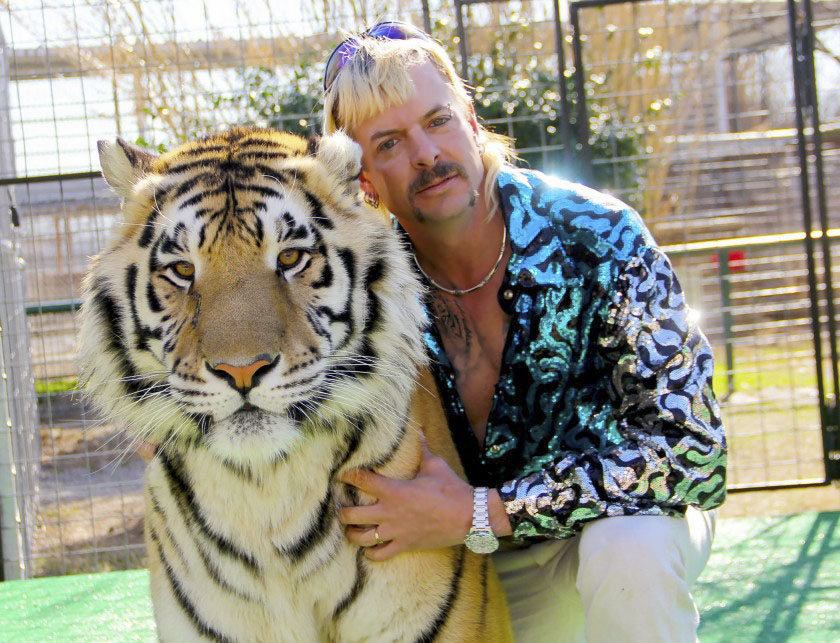 Joe+Exotic+poses+with+one+of+his+wild+cats+in+Tiger+King.+%28Netflix%29
