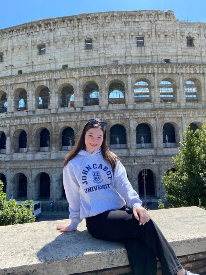 Kaplan sits in front of the Colosseum in her John Cabot University