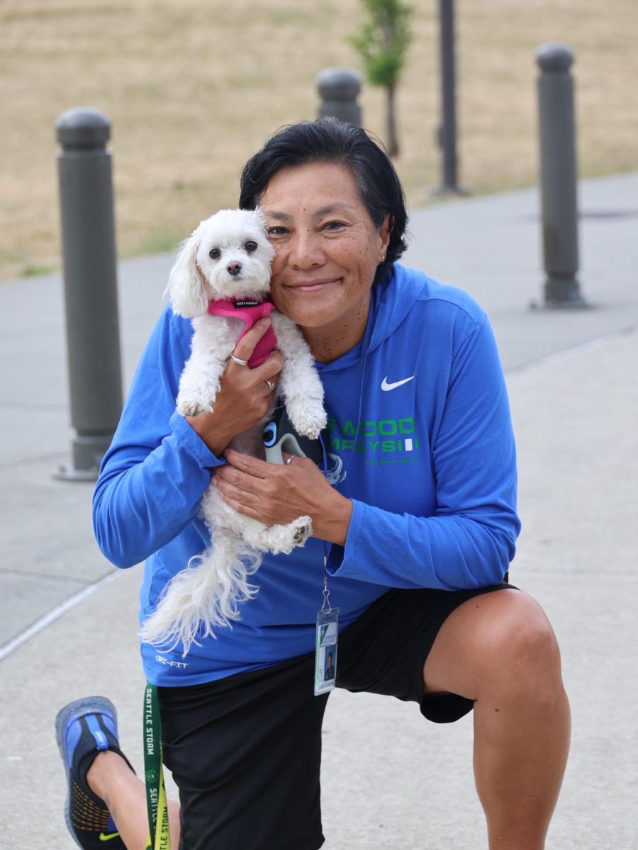 Athletic Director joann Fukuma poses for a picture with her maltipoo, Bella.