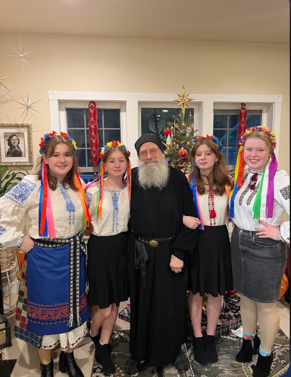 Ava Ponomarchuk with her sisters and grandfather in their cultural dress for Nativity