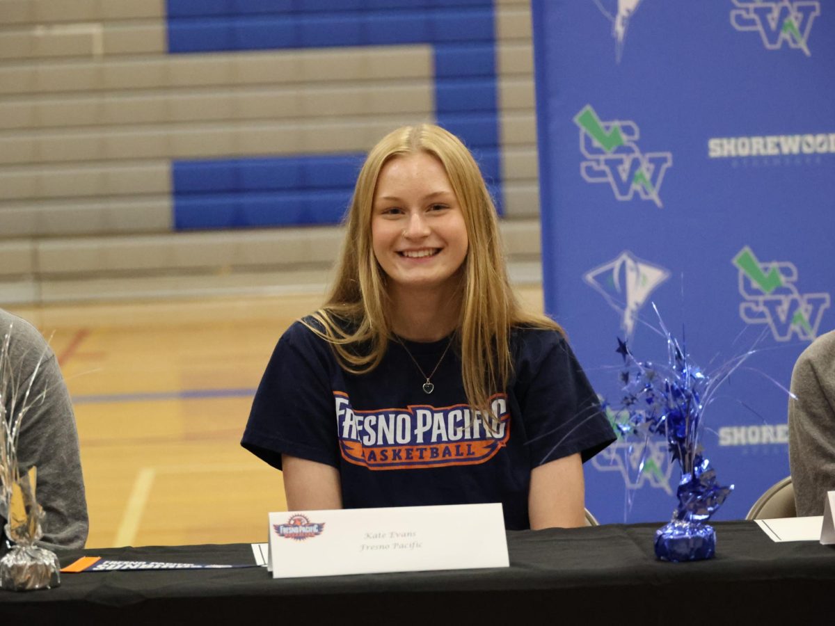 Kate Evans smiling after signing for Fresno Pacific University