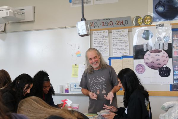 Michael Zadra teaches his students in ceramic class.